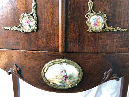 A mahogany cabinet with porcelain panels and brass filigree W.68cm